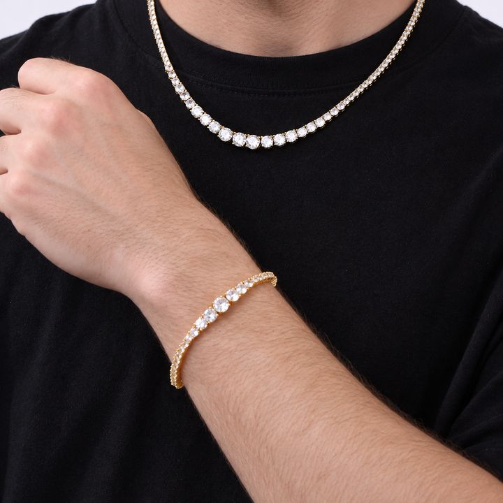 Adult model wearing a gold-tone graduated tennis necklace and matching bracelet