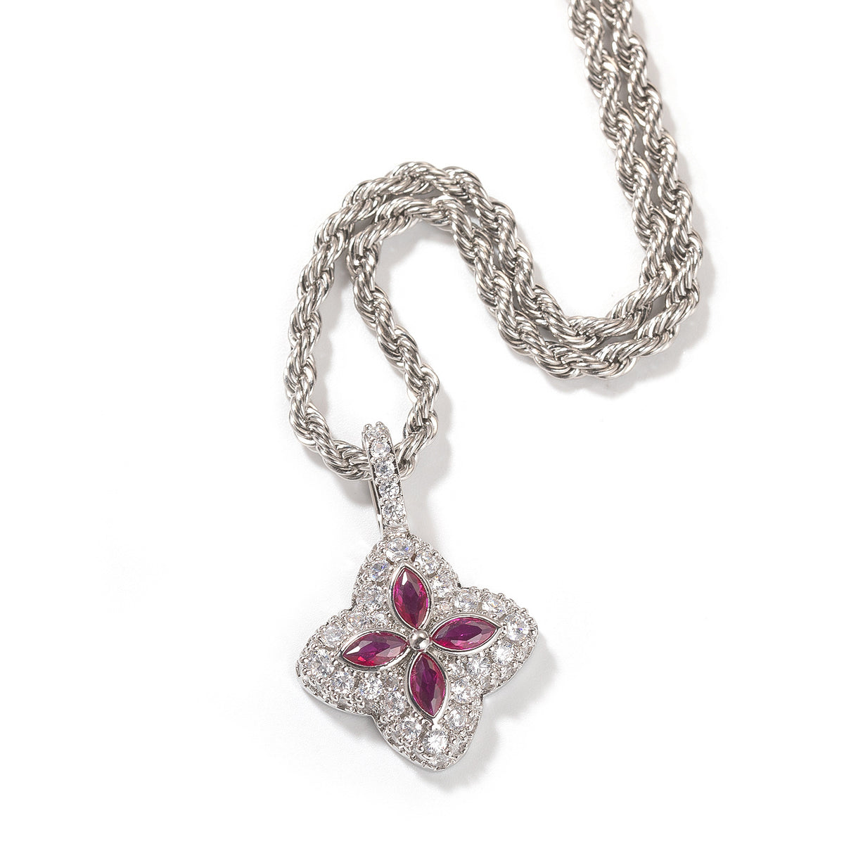 Ruby-red four-leaf clover pendant in a silver-tone setting on white