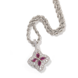 Ruby-red four-leaf clover pendant in a silver-tone setting on white