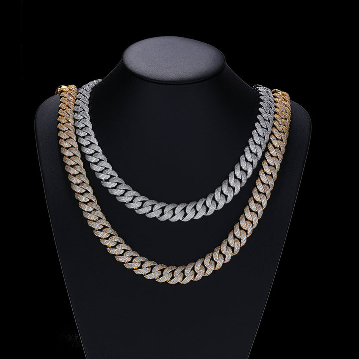 Silver- and gold-tone pavé Cuban necklaces draped on a black display bust