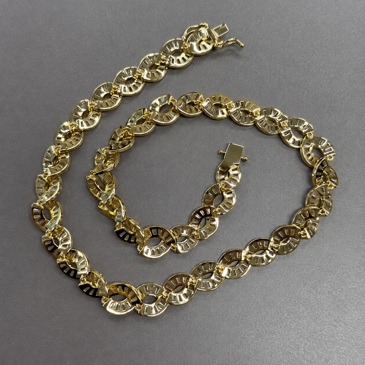 Gold-tone DNA spiral necklace turned over to show the backs of the links and open clasp