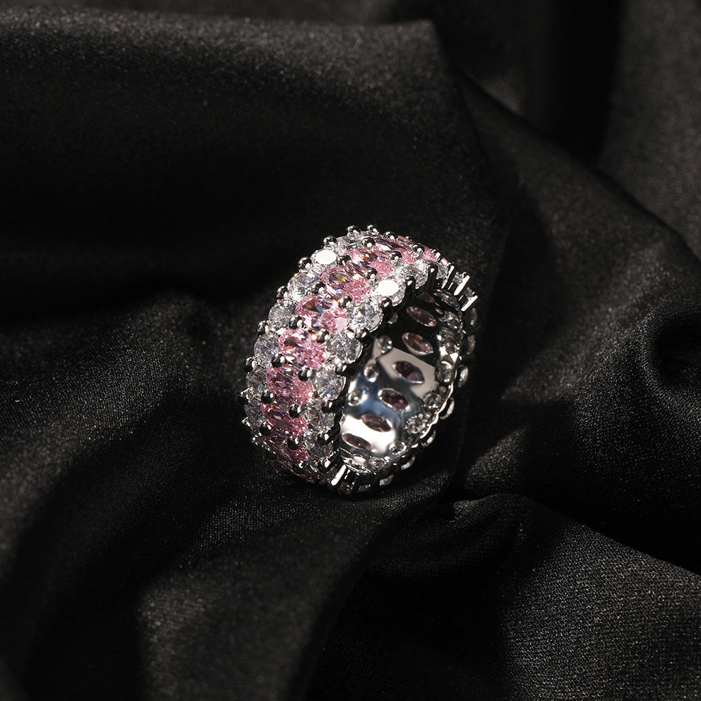 Angled pink-stone three-row ring on black fabric