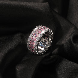 Angled pink-stone three-row ring on black fabric