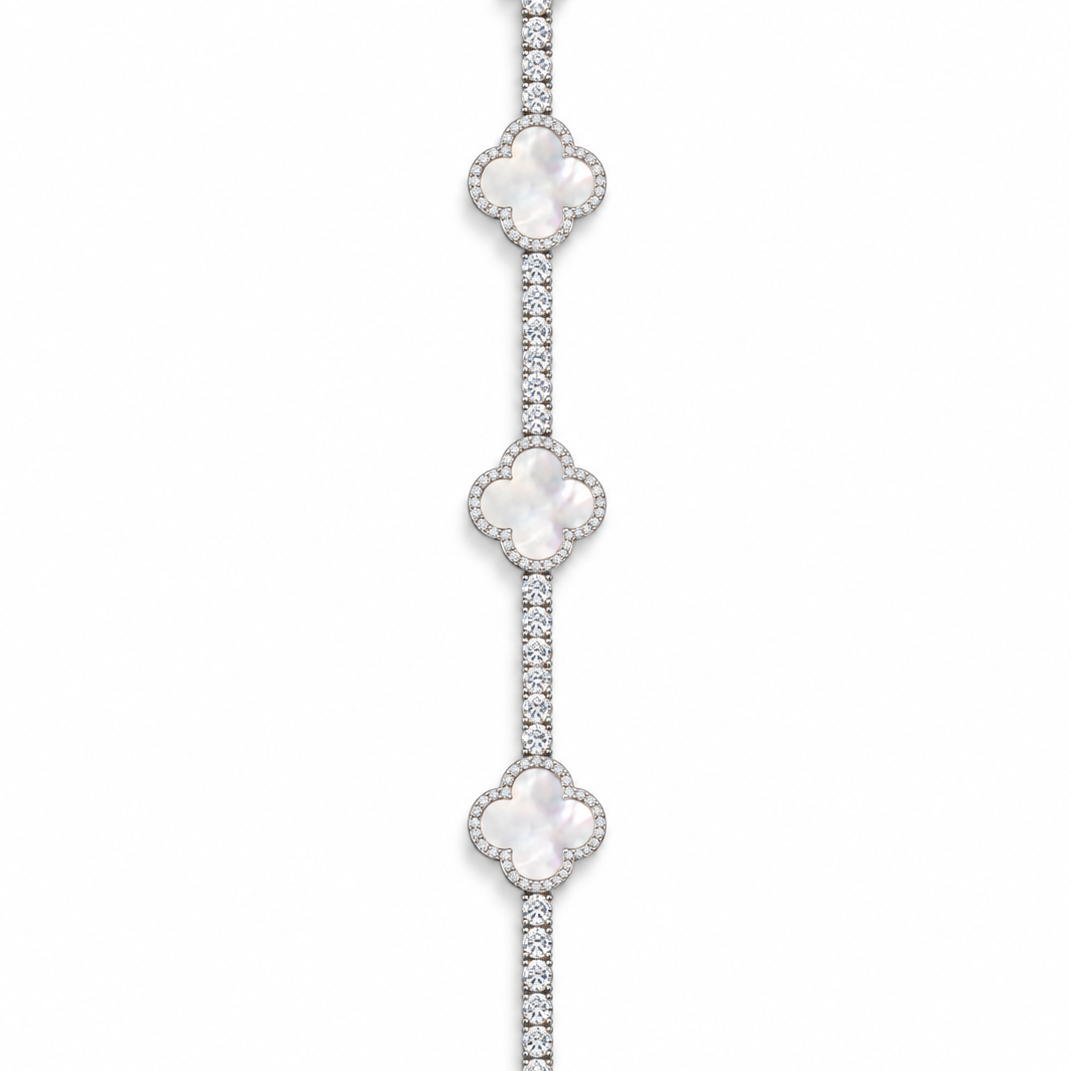 Silver-tone tennis bracelet with pearlescent white clover inlays displayed open on white