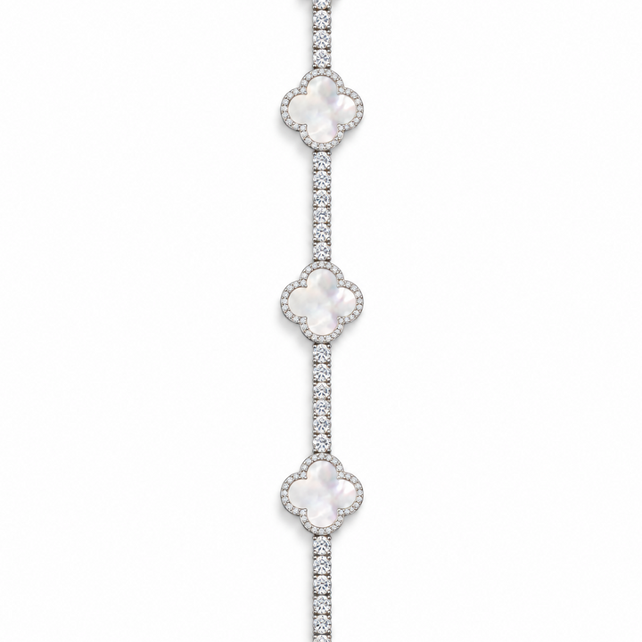 Silver-tone tennis bracelet with pearlescent white clover inlays displayed open on white