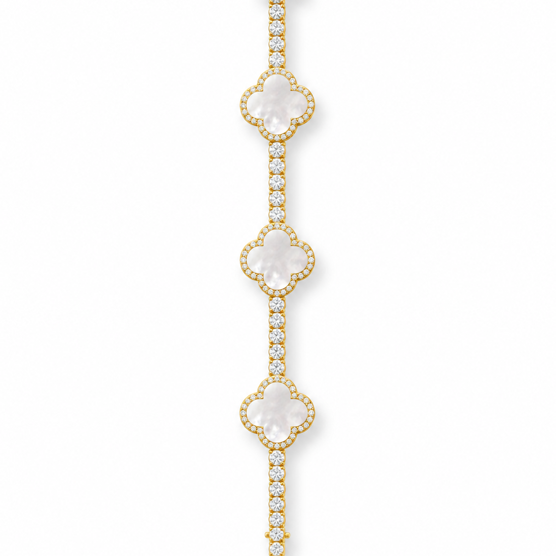 Gold-tone tennis bracelet with pearlescent white clover inlays displayed open on white