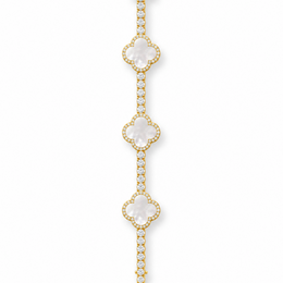 Gold-tone tennis bracelet with pearlescent white clover inlays displayed open on white