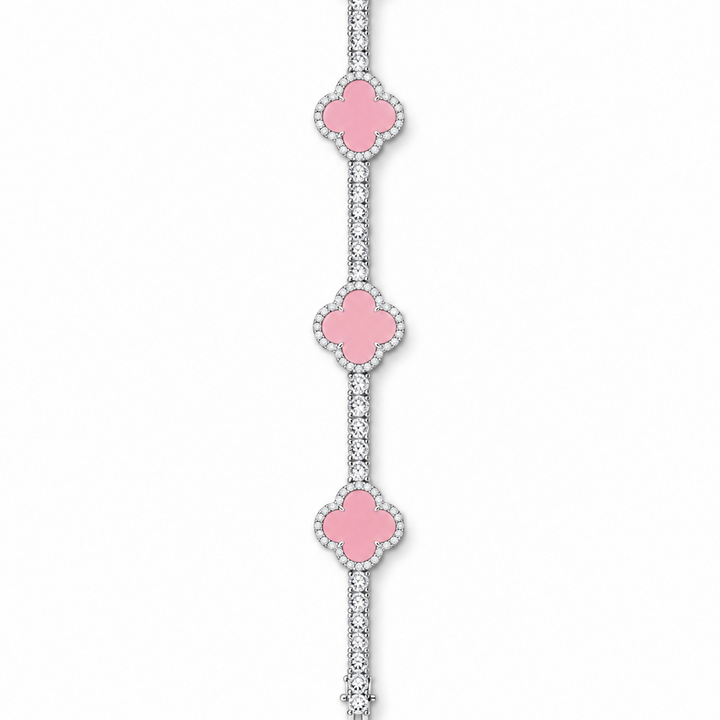 Silver-tone tennis bracelet with pink clover inlays displayed open on white