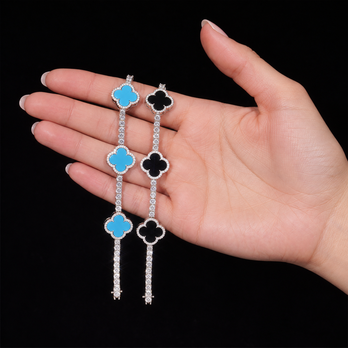 Blue and Black clover tennis bracelets displayed across an adult hand
