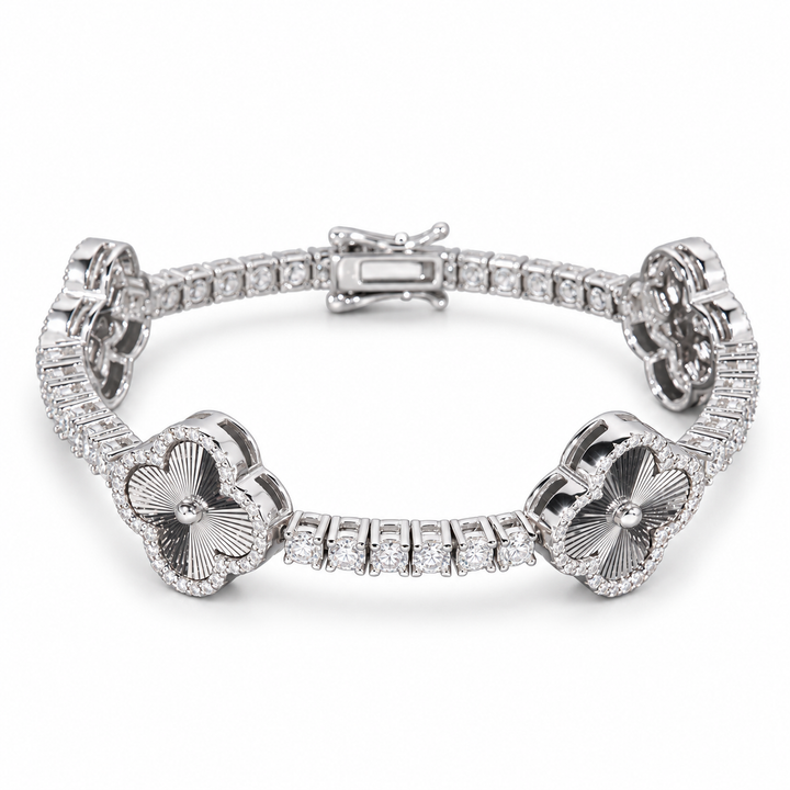 Silver-tone engraved clover tennis bracelet with clear stone halos on white
