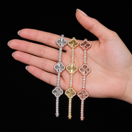 Silver, Gold and Rose Gold engraved clover bracelets displayed across an adult hand