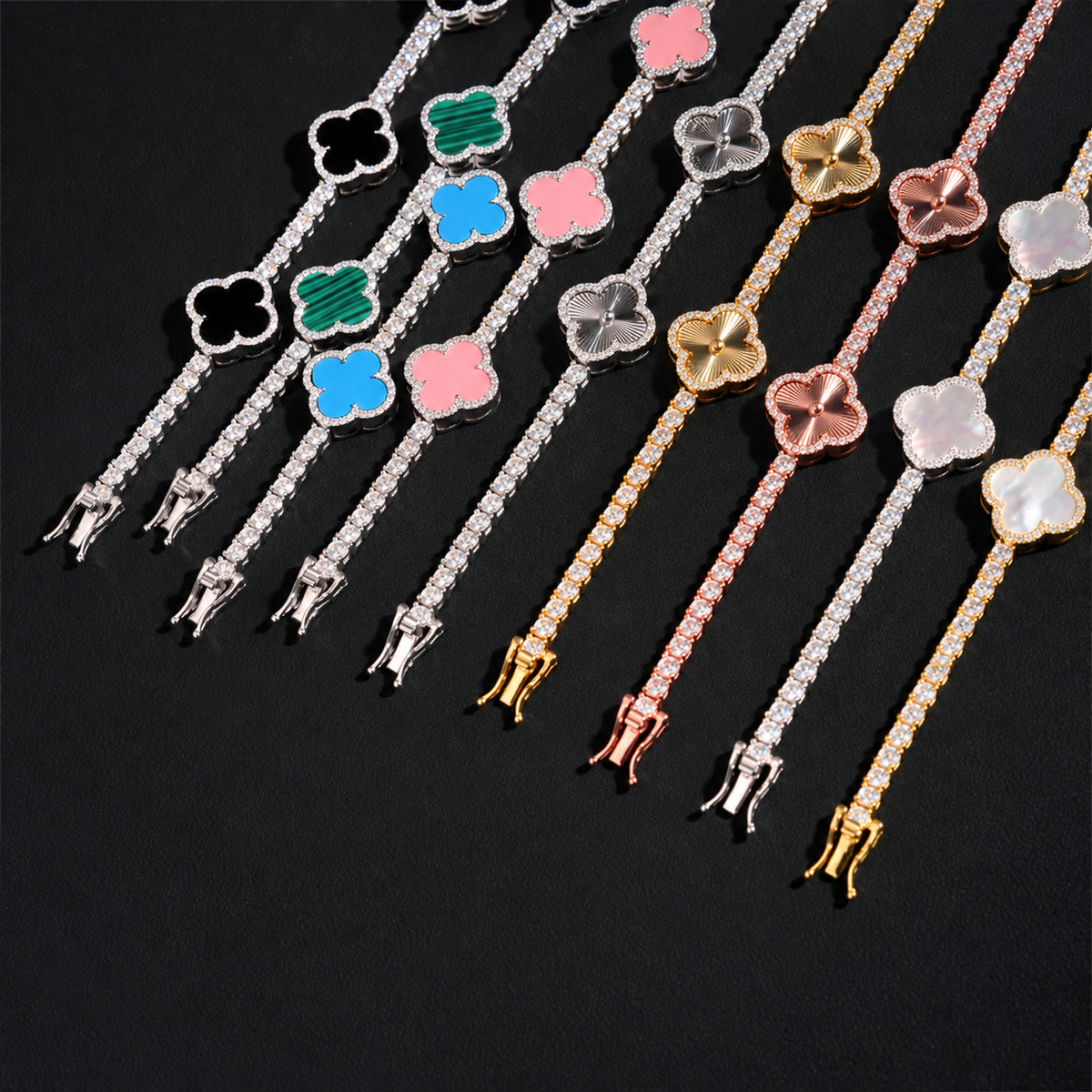 Comparison of engraved and color inlay clover tennis bracelets arranged diagonally on black