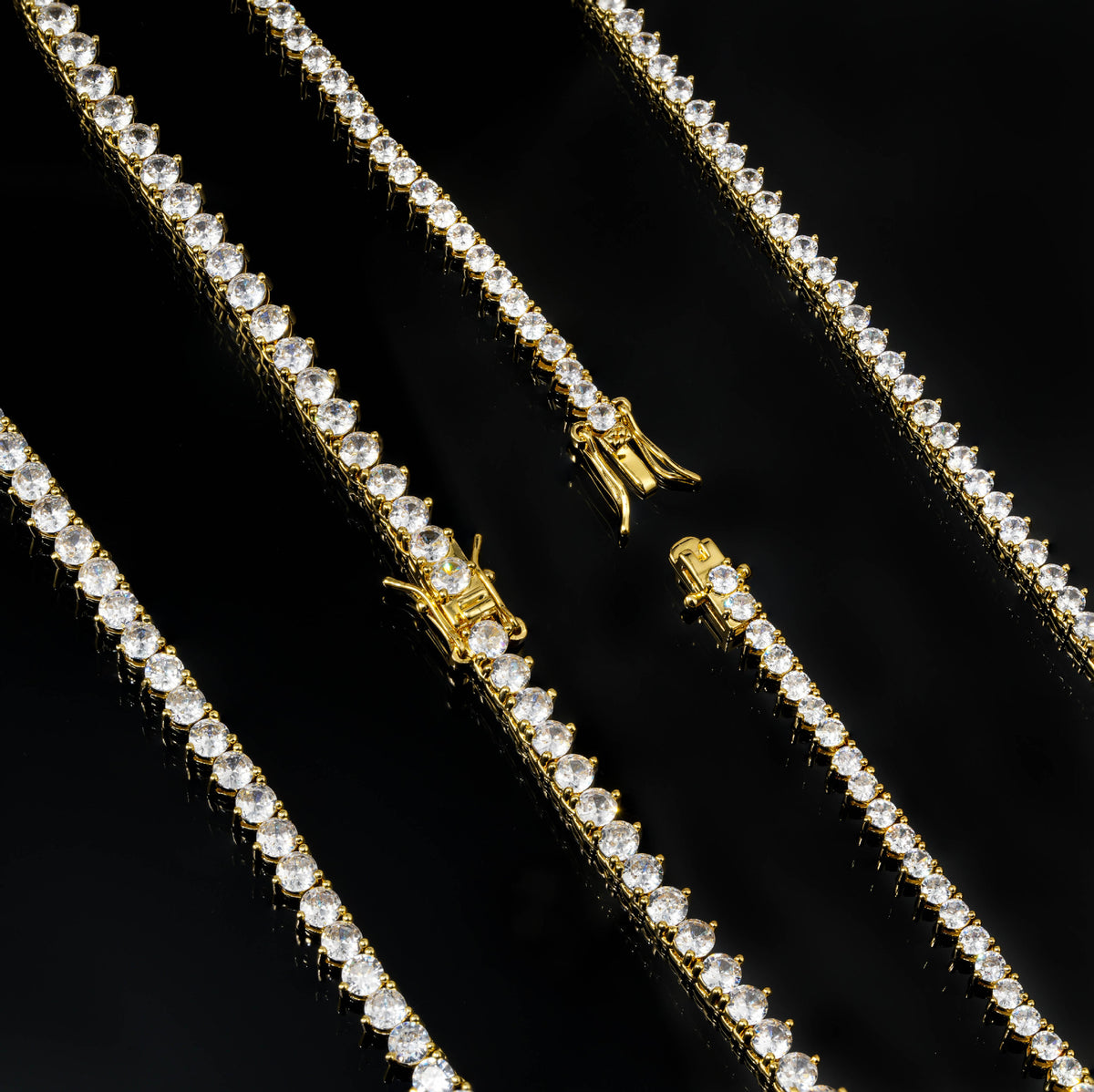 Close-up of box clasps and three-prong tennis settings in Gold