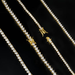 Close-up of box clasps and three-prong tennis settings in Gold