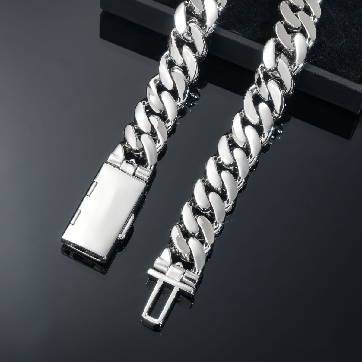Underside of silver-tone Cuban links and the open box clasp