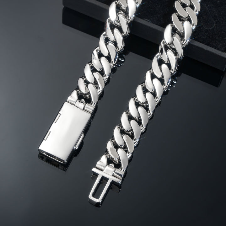 Underside of silver-tone Cuban links and the open box clasp