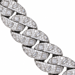 Close-up of silver-tone Cuban links with square and marquise accents on white