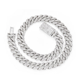 Silver-tone Cuban necklace coiled on white with its box clasp open