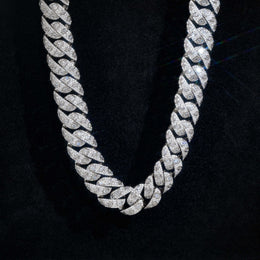 Close-up of silver-tone Cuban links showing square and marquise accents