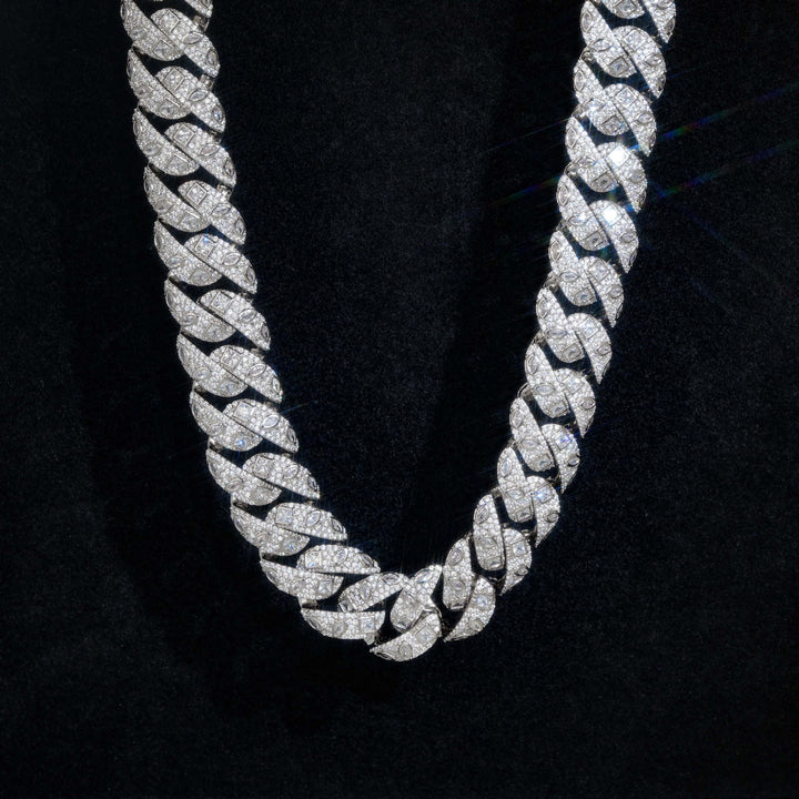Close-up of silver-tone Cuban links showing square and marquise accents