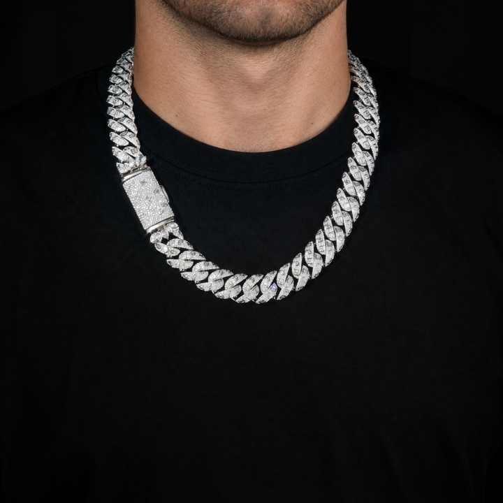 Adult model wearing a silver-tone Cuban necklace with a stone-set box clasp