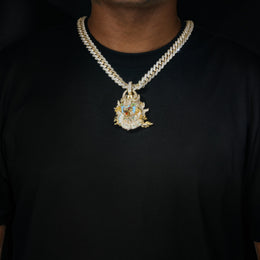 Gold iced dragon pendant worn over a black shirt