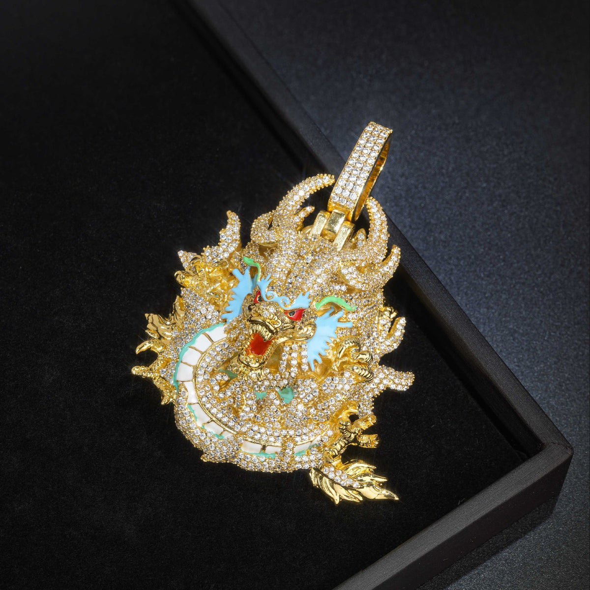 Gold iced dragon pendant angled in a black box