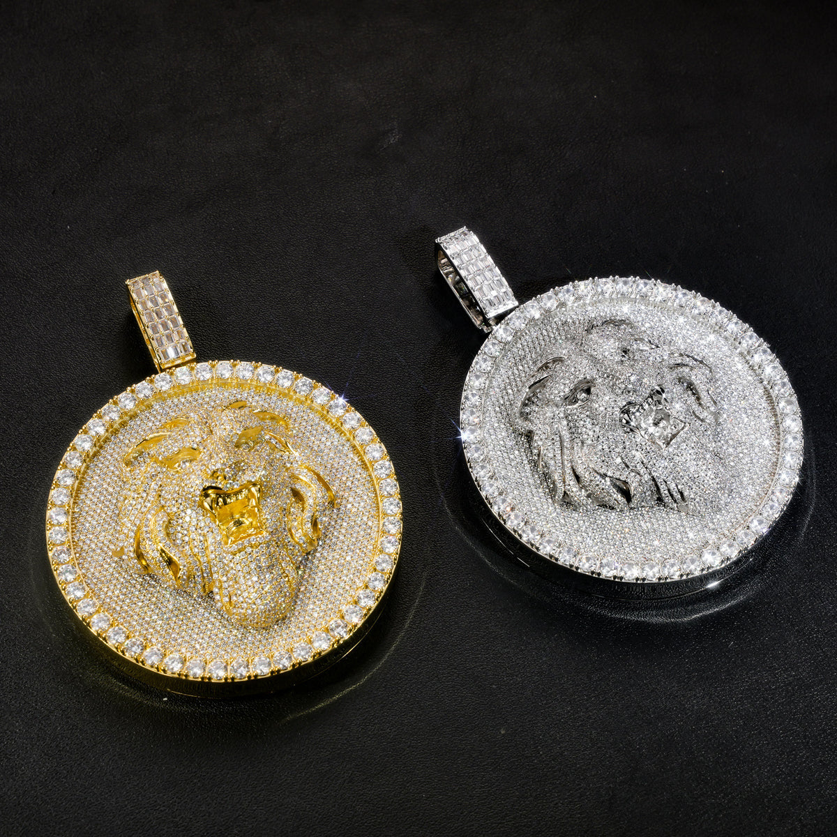 Gold and silver-tone lion medallion pendants angled on black leather