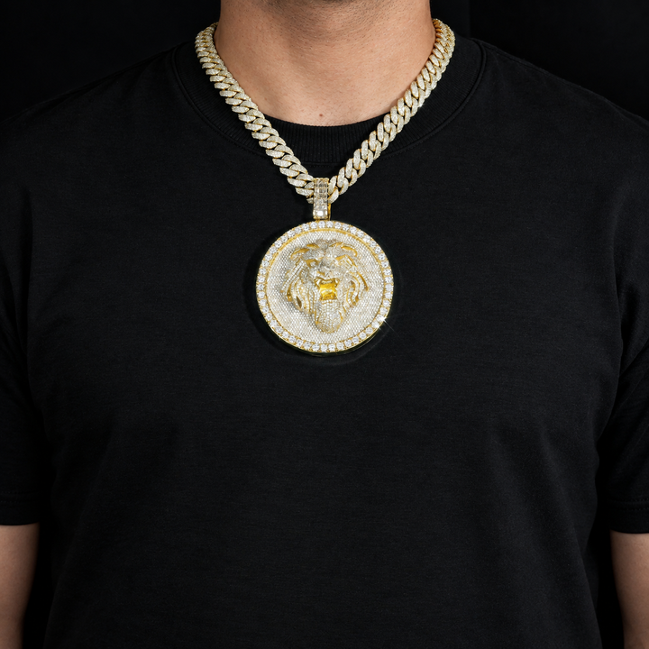Gold-tone lion medallion pendant worn over a black T-shirt