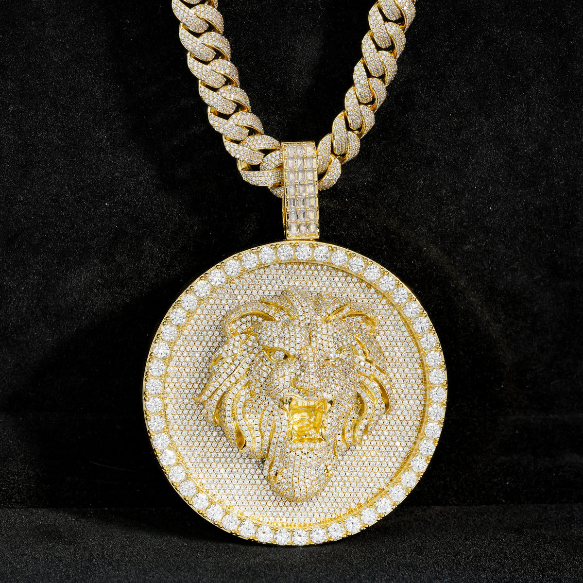 Gold-tone lion medallion pendant front view against black fabric