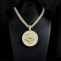 Gold-tone lion medallion pendant on a black display bust