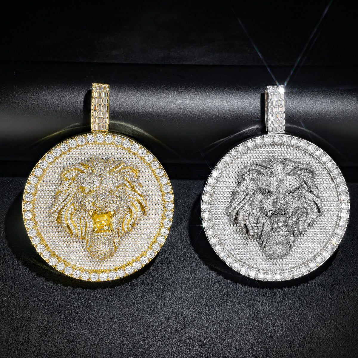 Gold and silver-tone lion medallion pendants on a rolled black display