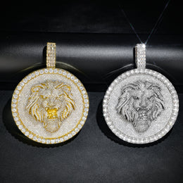 Gold and silver-tone lion medallion pendants on a rolled black display