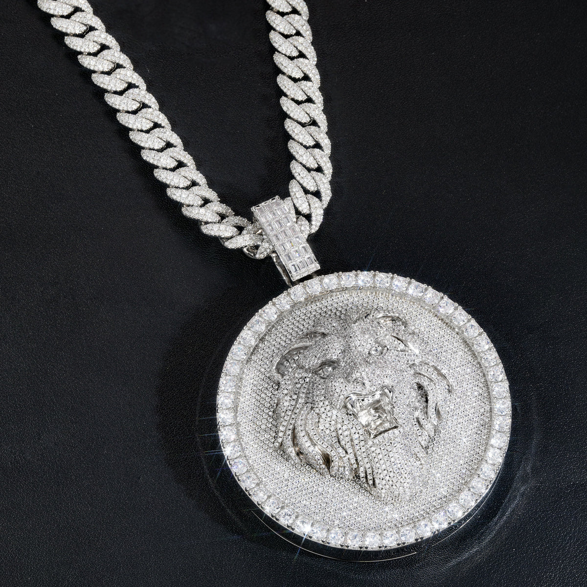 Silver-tone lion medallion pendant angled across black leather