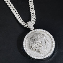 Silver-tone lion medallion pendant angled across black leather