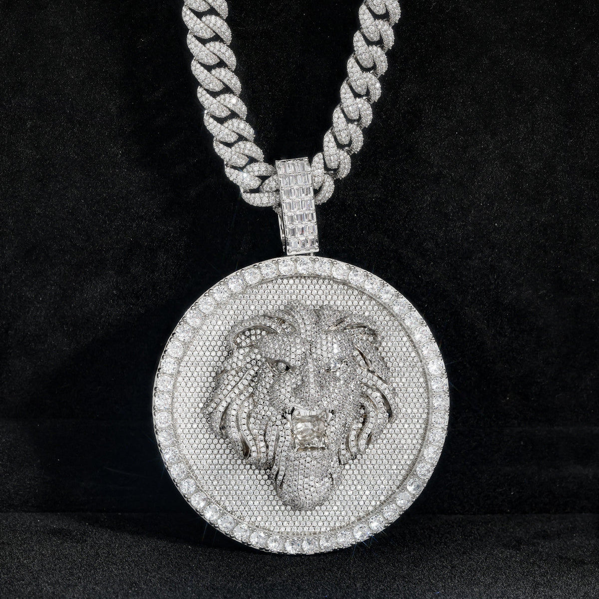 Silver-tone lion medallion pendant front view against black fabric