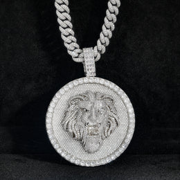 Silver-tone lion medallion pendant front view against black fabric