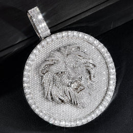 Silver-tone lion medallion pendant resting diagonally on a black box