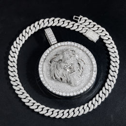 Silver-tone lion medallion pendant laid flat on black leather