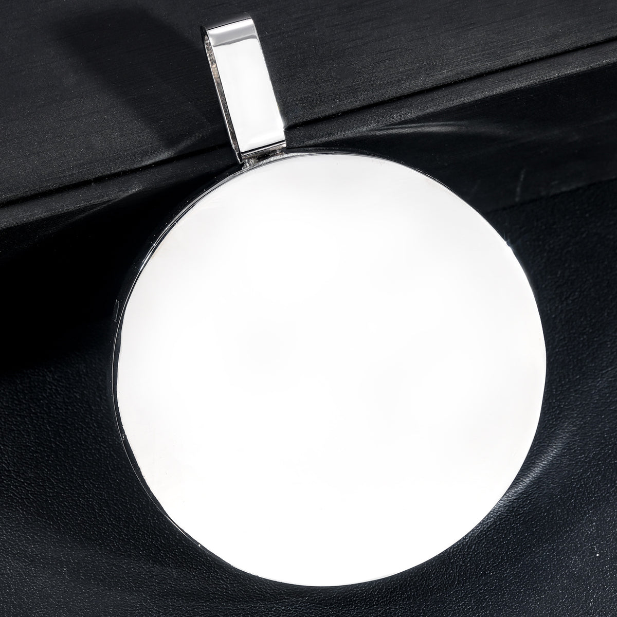 Polished silver-tone back and bail of the lion medallion pendant
