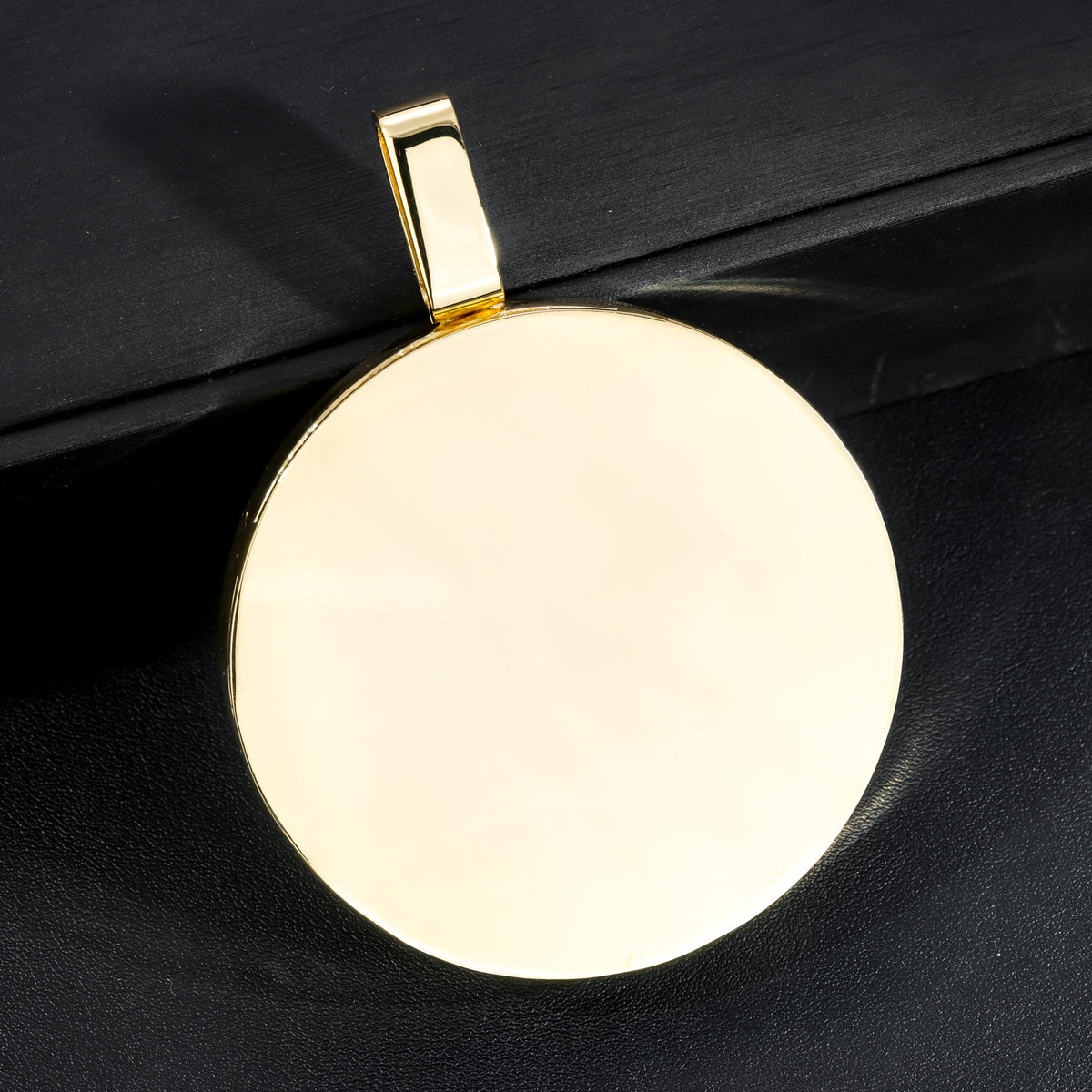 Polished gold-tone back and bail of the lion medallion pendant