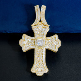 Gold oversized iced cross pendant on a blue display