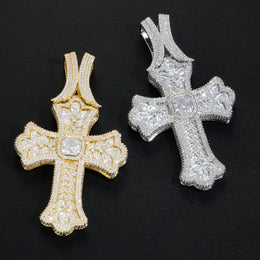 Gold and silver oversized iced cross pendants angled view