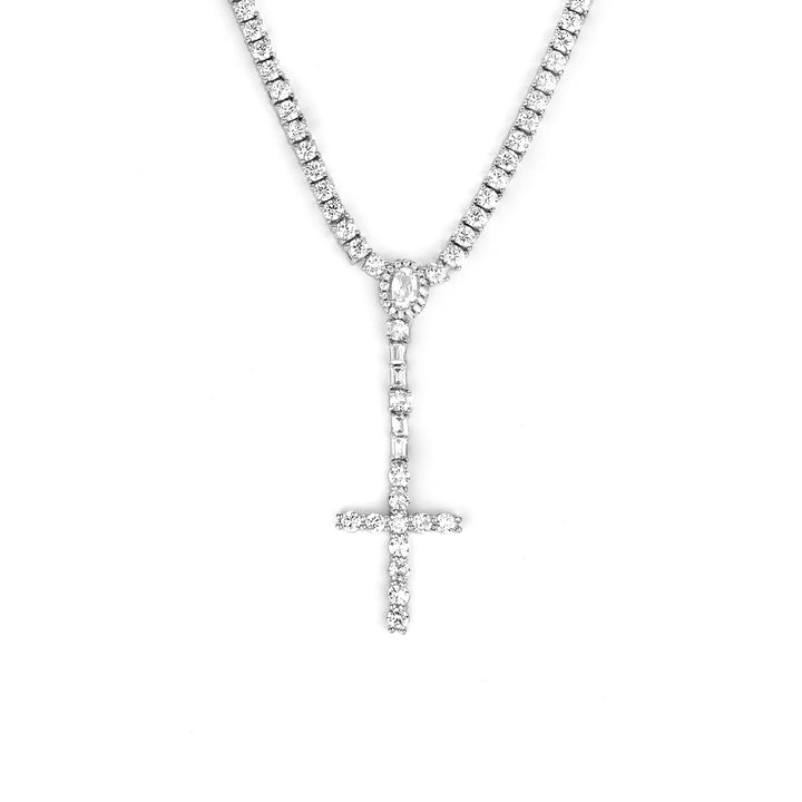 Silver-tone cross drop tennis necklace with an oval halo and rectangular stone accents on white