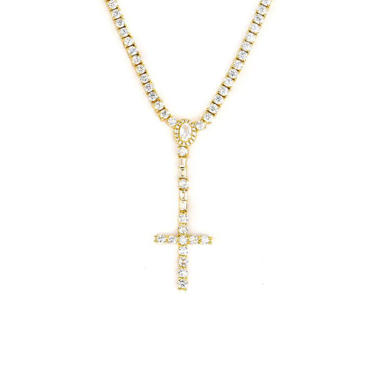 Gold-tone cross drop tennis necklace with an oval halo and rectangular stone accents on white