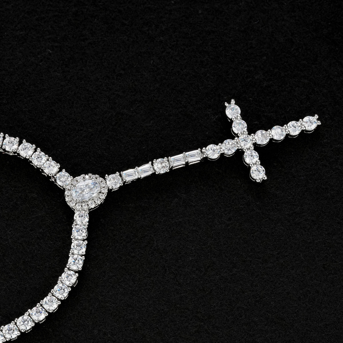 Slender silver-tone cross drop necklace with an oval halo and rectangular accents on black