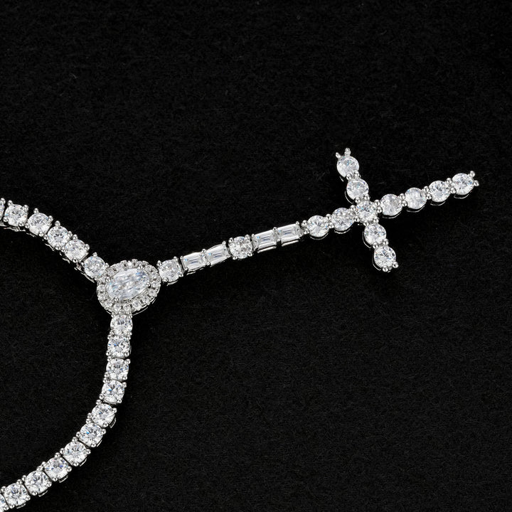 Slender silver-tone cross drop necklace with an oval halo and rectangular accents on black