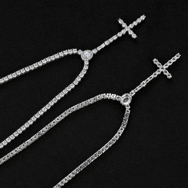 Front and reverse of the slender silver-tone cross drop tennis necklace showing open settings
