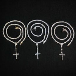 Gold, Silver and Rose Gold slender cross drop tennis necklaces in coils on black