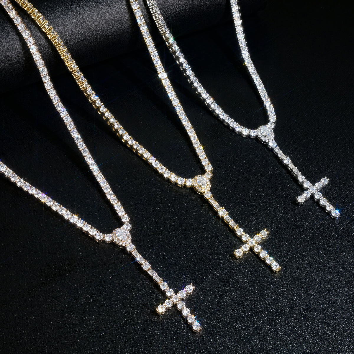 Rose Gold, Gold and Silver slender cross drop necklaces draped over a black display roll